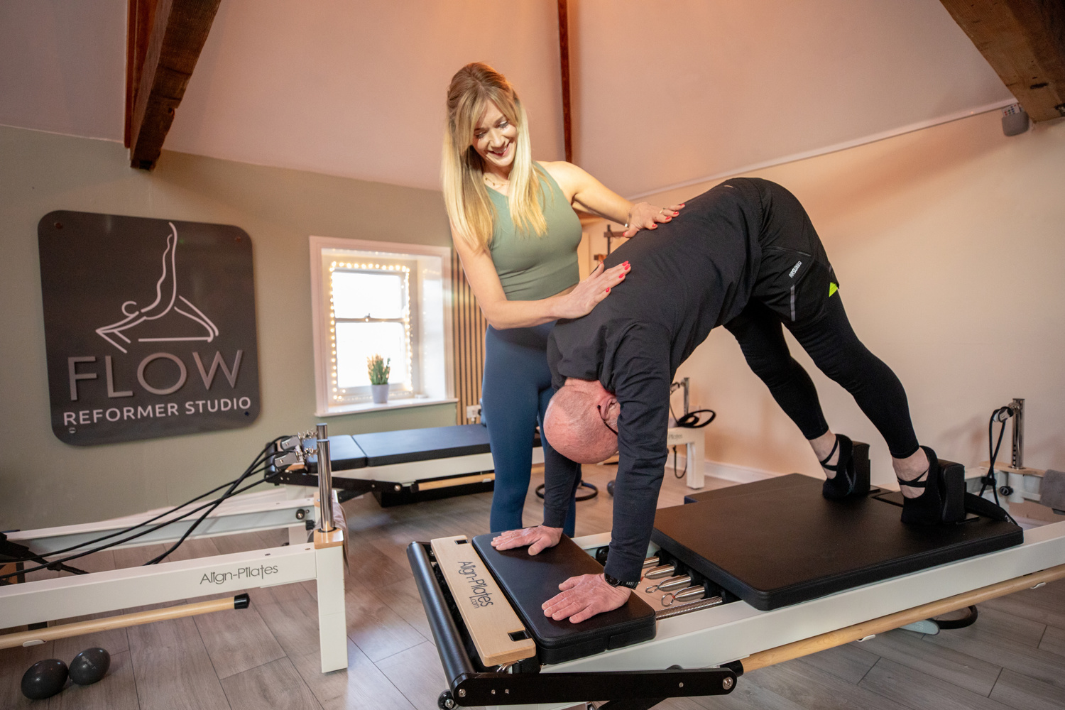 Instructor providing hands on corrections at Flow Reformer Studio Bottesford