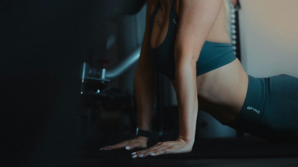 a woman holding a stretch to benefit her body composition